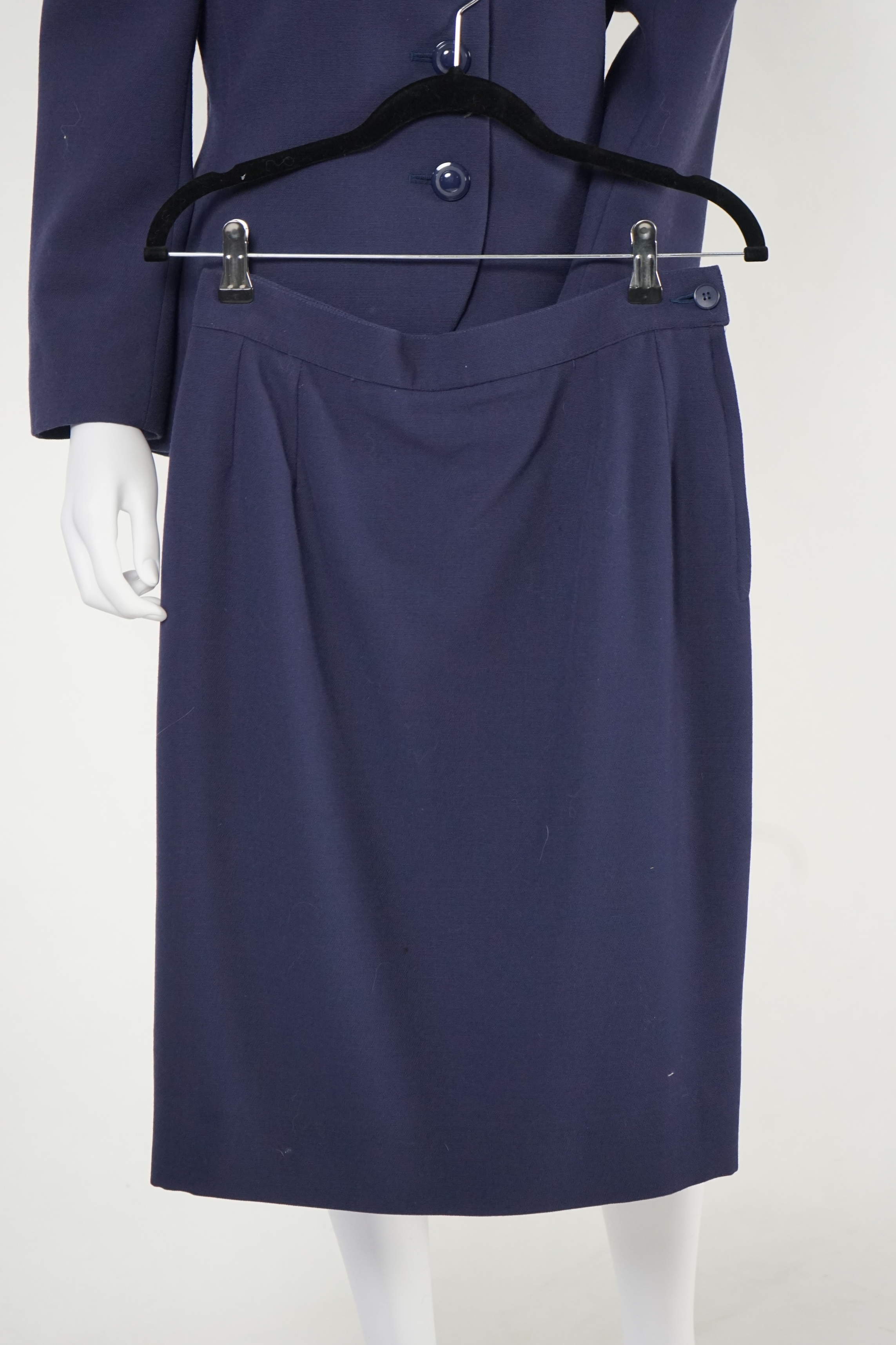 A vintage Yves Saint Laurent variation lady's navy wool skirt suit, F 42 (UK 14).Please note alterations to make the waist smaller may have been carried out on some of the skirts. Proceeds to Happy Paws Puppy Rescue.